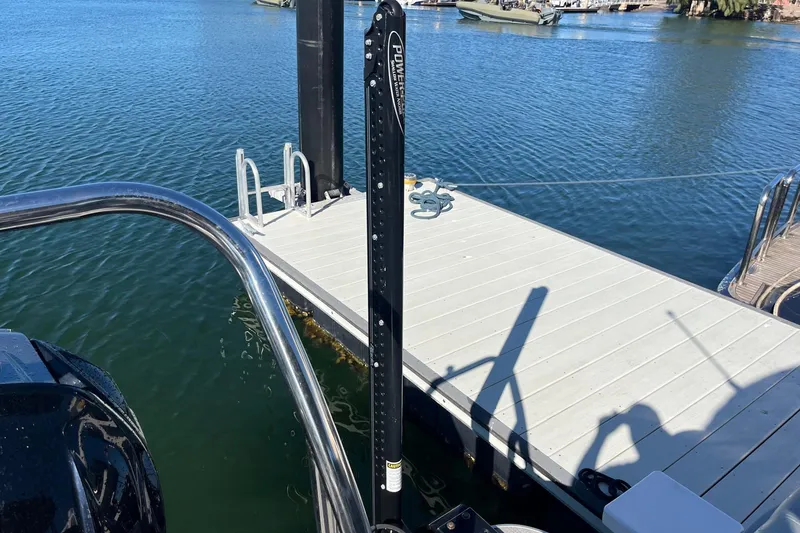 Slide: The Image of 2023 Veranda Relax VR22RC pontoon boat docked by a wooden pier. - 7