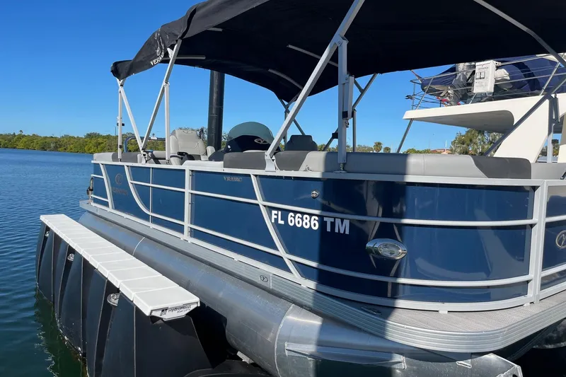 Slide: The Image of 2023 Veranda Relax VR22RC boat dashboard with Garmin display and steering wheel. - 9