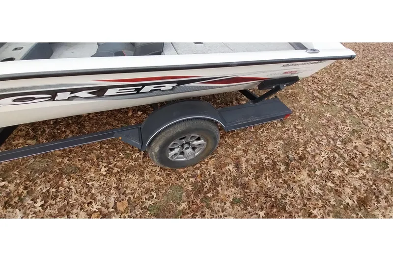 Slide: The Image of 2022 Tracker Pro Team 195 TXW boat on trailer, surrounded by autumn leaves. - 12
