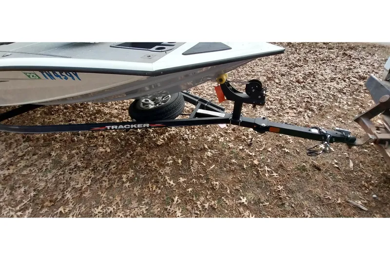 Slide: The Image of 2022 Tracker Pro Team 195 TXW boat trailer on leaf-covered ground. - 14