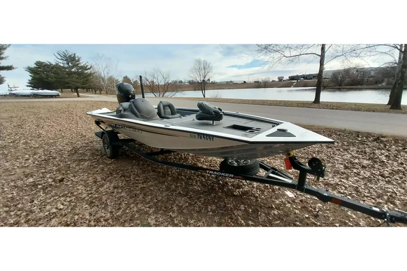 Slide: The Image of 2022 Tracker Pro Team 195 TXW boat on trailer by a lakeside park. - 21