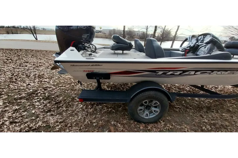 Slide: The Image of 2022 Tracker Pro Team 195 TXW boat on trailer, parked on leaf-covered ground. - 25