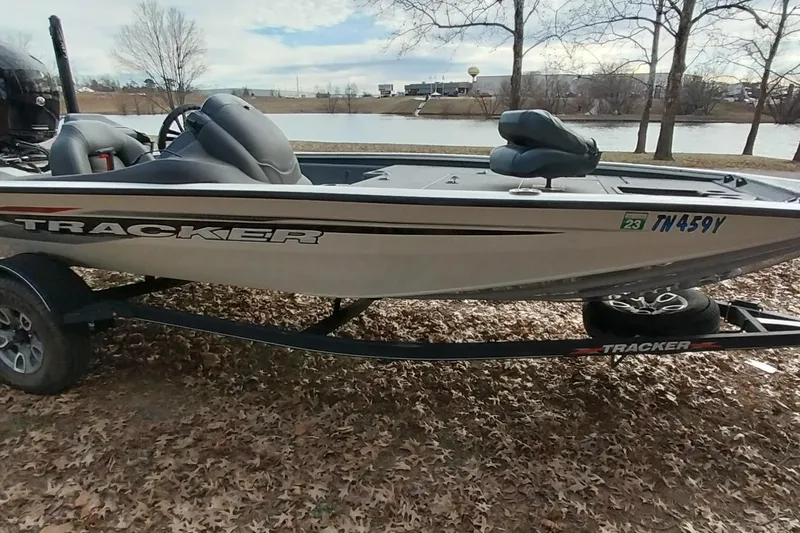 Slide: The Image of 2022 Tracker Pro Team 195 TXW boat on trailer by a lake in autumn setting. - 27