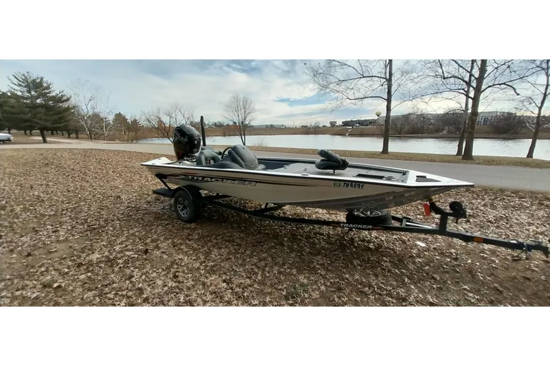 Slide: The Image of 2022 Tracker Pro Team 195 TXW boat on trailer by a lakeside park. - 28
