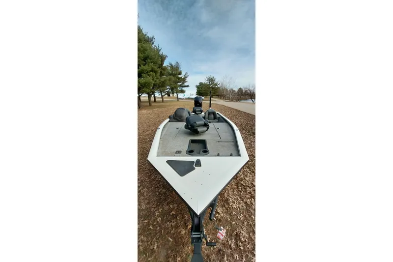 Slide: The Image of 2022 Tracker Pro Team 195 TXW boat on a leaf-covered ground near trees. - 29