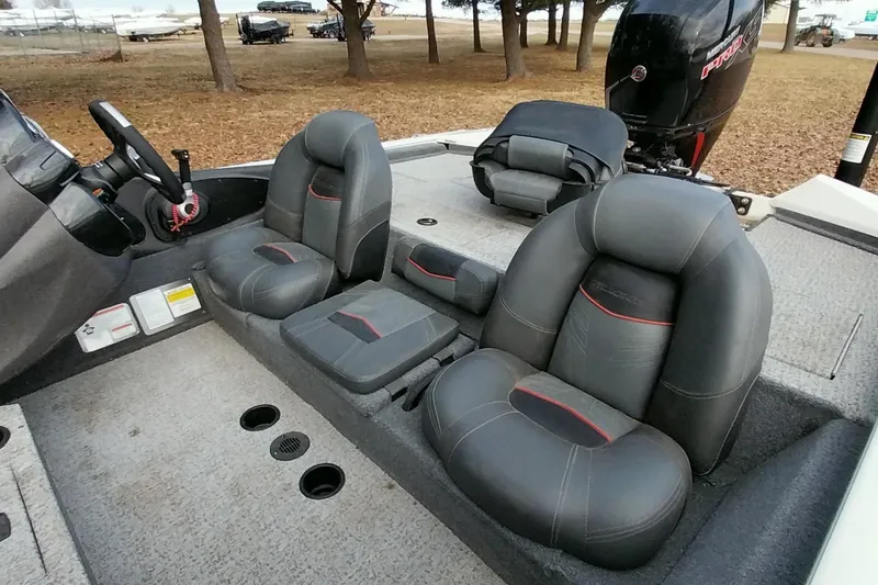 Slide: The Image of 2022 Tracker Pro Team 195 TXW boat interior with gray seating and steering wheel. - 3