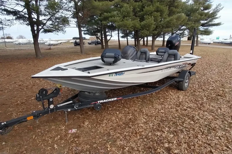 Slide: The Image of 2022 Tracker Pro Team 195 TXW fishing boat on trailer, parked in wooded area. - 31