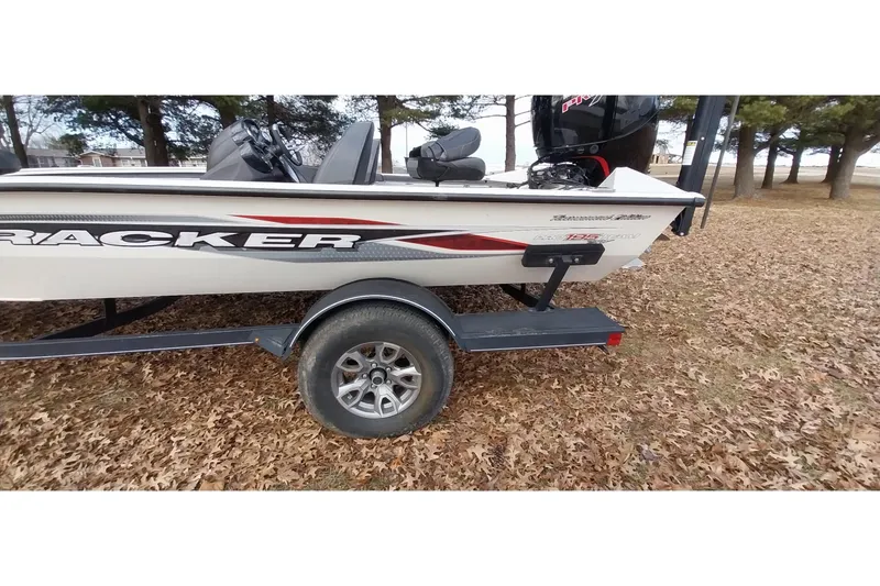 Slide: The Image of 2022 Tracker Pro Team 195 TXW boat on trailer, parked on leaf-covered ground. - 32