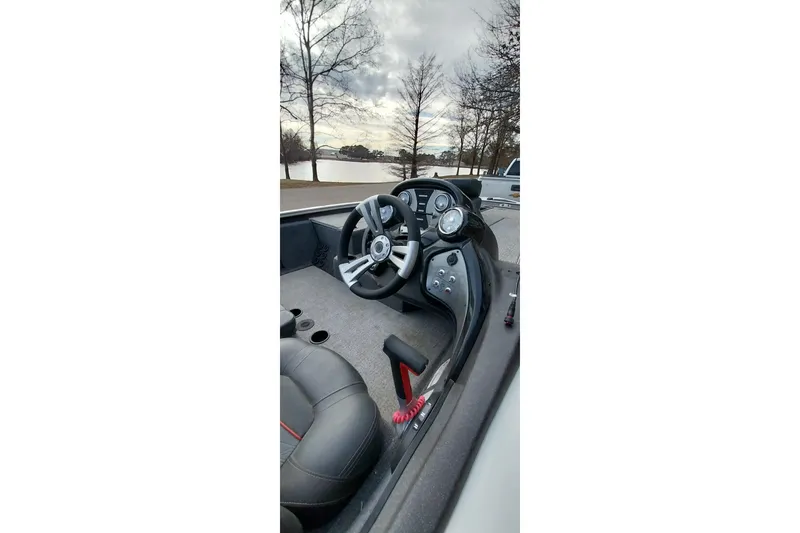 Slide: The Image of 2022 Tracker Pro Team 195 TXW boat interior with steering wheel and dashboard controls. - 7