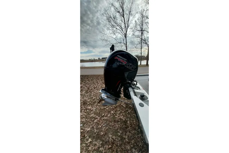 Slide: The Image of 2022 Tracker Pro Team 195 TXW boat with Mercury Pro XS engine by a lake. - 9