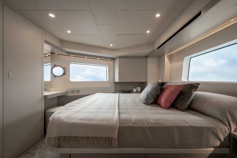 Slide: The Image of Elegant bedroom with a large bed, modern furnishings, and big windows offering sea views. - 33