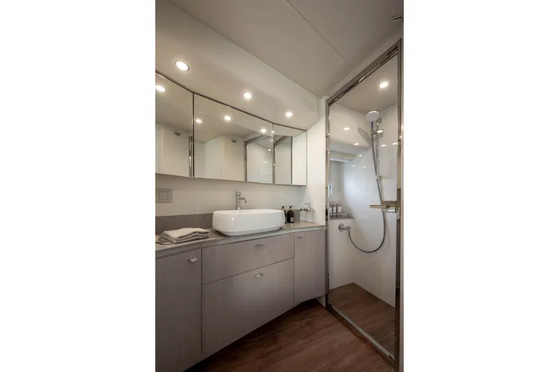 Slide: The Image of Modern bathroom with mirrors, sink, and shower cabin on a yacht. - 34