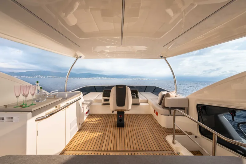 Slide: The Image of The image shows the cockpit of a 2027 Absolute 50 Navetta with sleek furnishings and a sea view. - 14