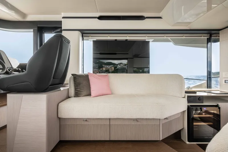 Slide: The Image of Interior of the 2027 Absolute 50 Navetta with elegant seating area and large windows overlooking the sea. - 27