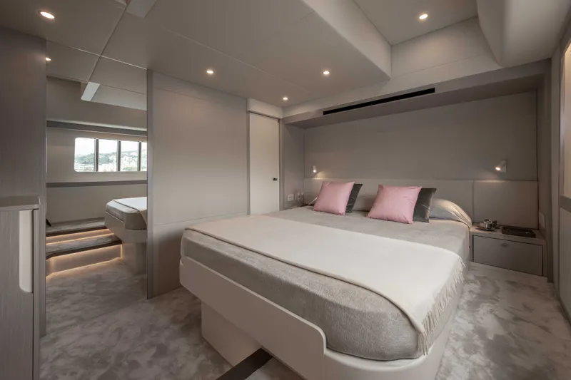 Slide: The Image of The image shows a luxurious cabin with a large bed, soft pillows, and modern lighting. - 35