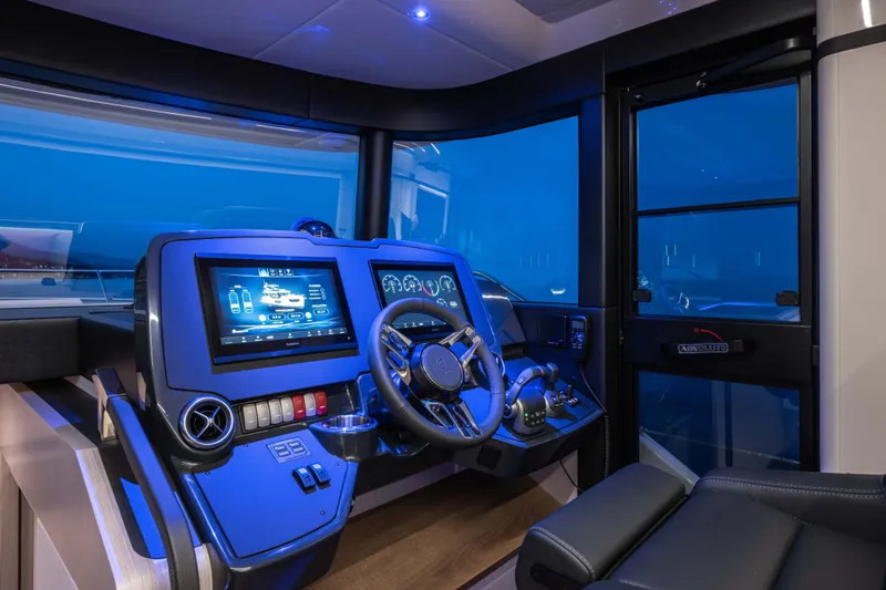 Slide: The Image of The image shows the modern helm of a 2027 Absolute 50 Navetta with advanced instruments. - 29