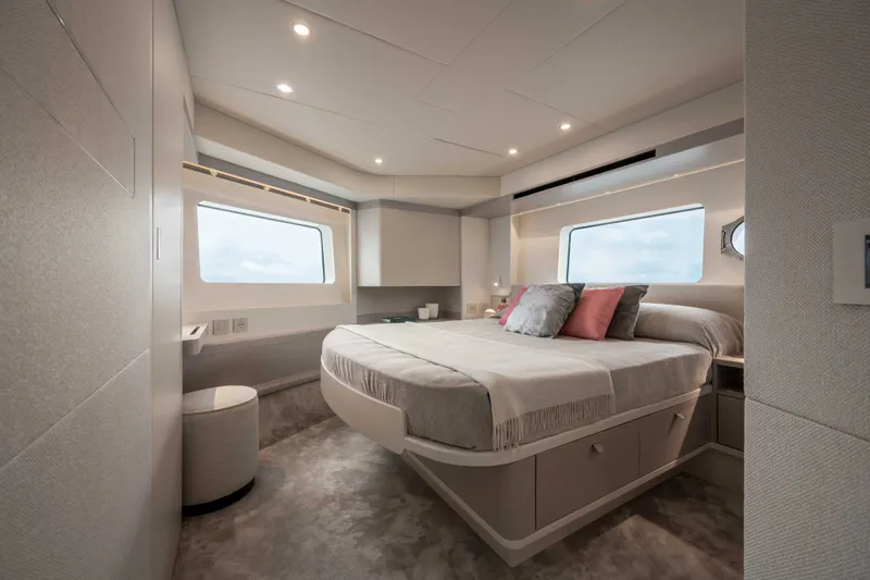 Slide: The Image of The image shows a luxurious cabin with a large bed, modern furnishings, and large windows. - 31