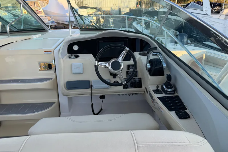 Slide: The Image of 2019 Regal 33 OBX boat cockpit with steering wheel and control panel. - 13