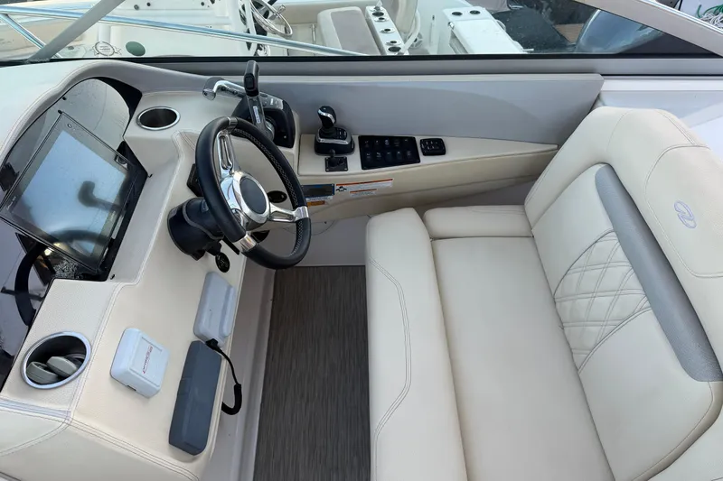 Slide: The Image of 2019 Regal 33 OBX boat cockpit with steering wheel and control panel. - 16