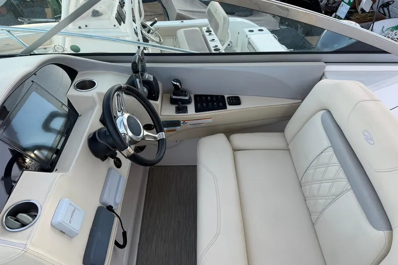 Slide: The Image of 2019 Regal 33 OBX boat cockpit with steering wheel and luxurious seating. - 17