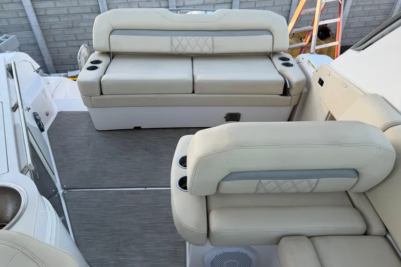 Slide: The Image of 2019 Regal 33 OBX boat interior with beige seating and cup holders. - 18