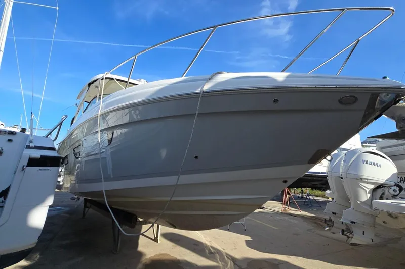 Slide: The Image of 2019 Regal 33 OBX boat on dry dock under clear blue sky. - 2