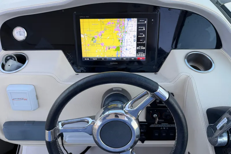 Slide: The Image of 2019 Regal 33 OBX boat dashboard with GPS navigation display and steering wheel. - 22