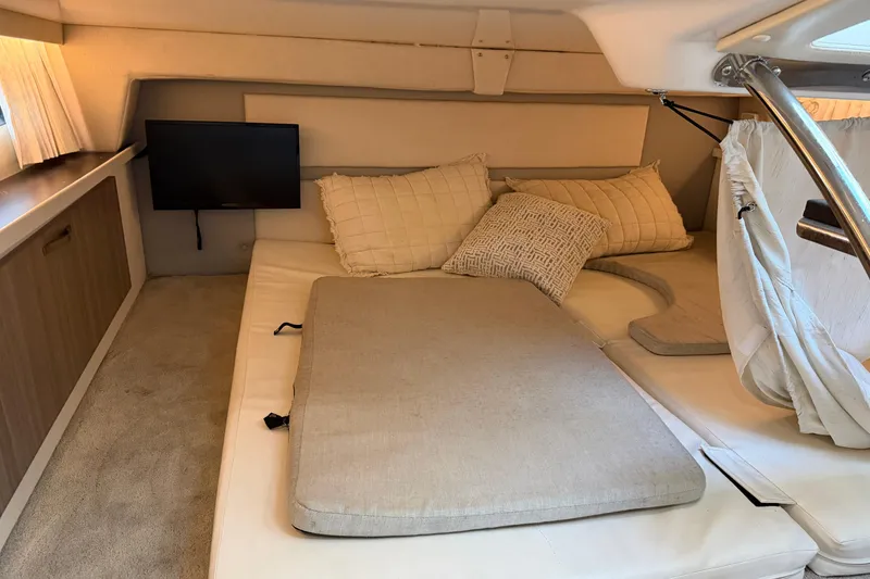 Slide: The Image of 2019 Regal 33 OBX cabin interior with cozy bedding and mounted TV. - 25