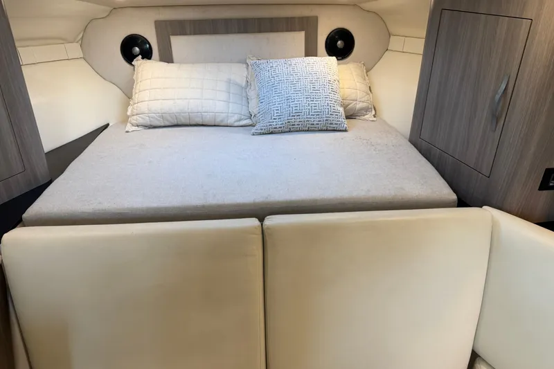 Slide: The Image of 2019 Regal 33 OBX cabin interior with cozy bed and pillows. - 27