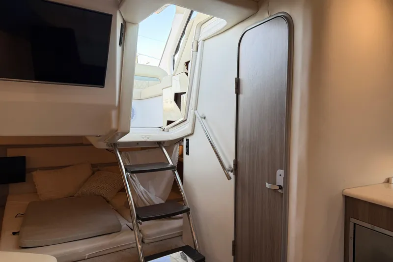 Slide: The Image of Interior of 2019 Regal 33 OBX boat with stairs, door, and seating area. - 30