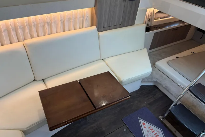 Slide: The Image of Interior of 2019 Regal 33 OBX yacht with white seating and wooden table. - 32