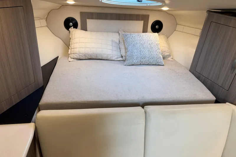 Slide: The Image of 2019 Regal 33 OBX cabin interior with cozy bed and modern design. - 33