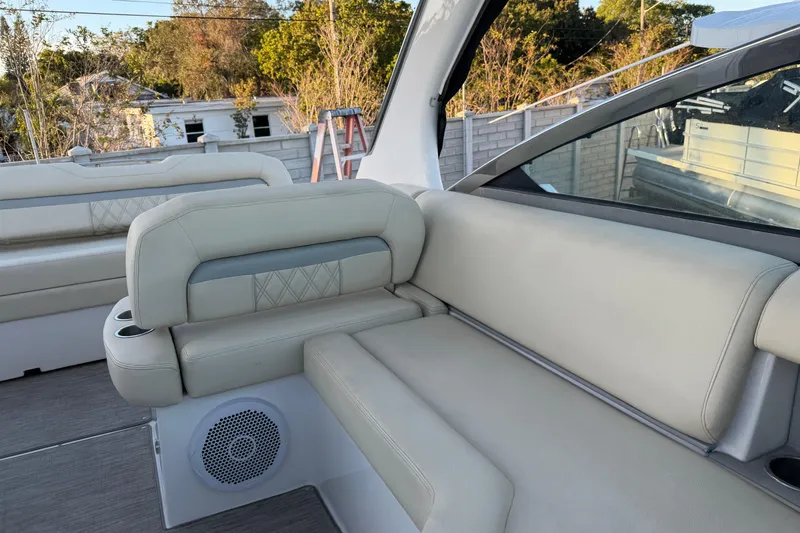 Slide: The Image of 2019 Regal 33 OBX boat interior with beige seating and speaker. - 36