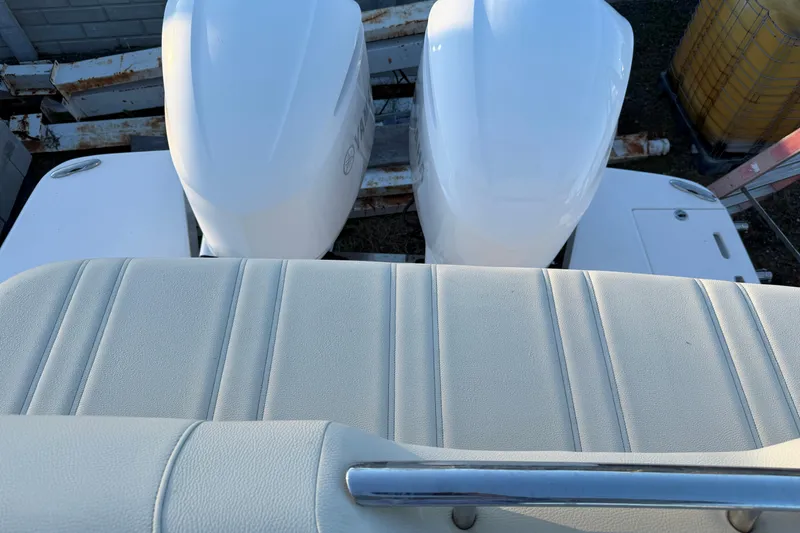 Slide: The Image of 2019 Regal 33 OBX boat with dual outboard engines and cushioned seating. - 37