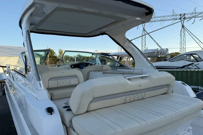 Slide: The Image of 2019 Regal 33 OBX boat with luxurious seating and sleek design in a marina setting. - 4