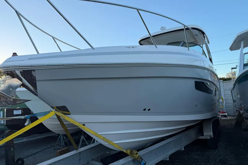 Slide: The Image of 2019 Regal 33 OBX boat on trailer, secured with straps, side view. - 40