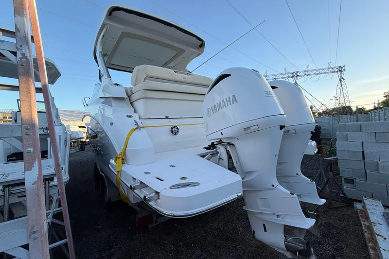 Slide: The Image of 2019 Regal 33 OBX boat with twin Yamaha outboard engines, docked outdoors. - 41