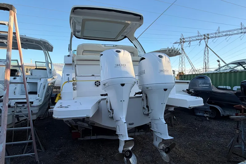 Slide: The Image of 2019 Regal 33 OBX boat with twin Yamaha 300 engines, docked outdoors. - 42