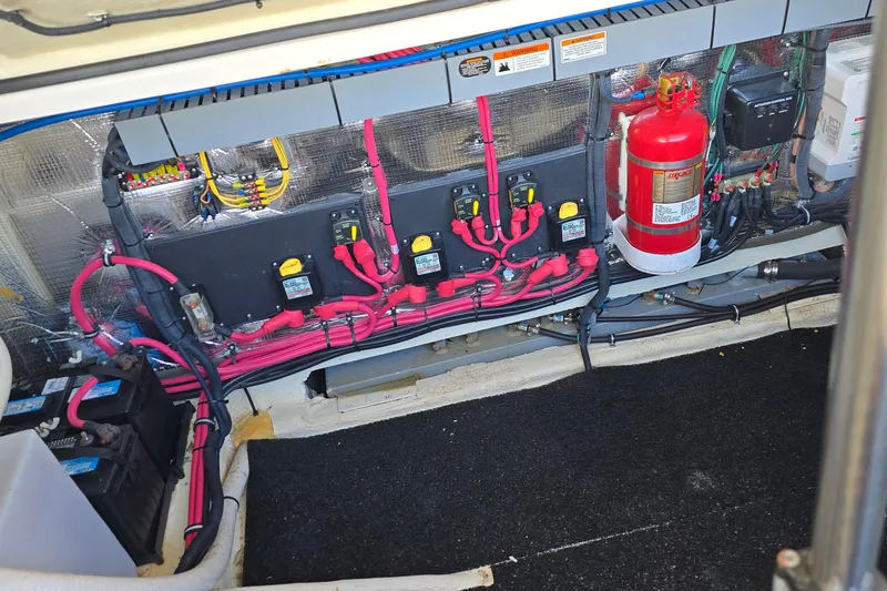 Slide: The Image of 2019 Regal 33 OBX engine compartment with wiring, fire extinguisher, and battery setup. - 44
