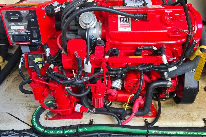 Slide: The Image of Red engine of a 2019 Regal 33 OBX boat, featuring EFI system and wiring. - 45