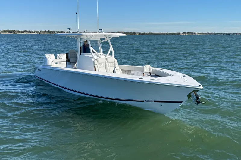 Slide: The Image of 2026 Jupiter 32 boat cruising on open water under clear blue sky. - 10