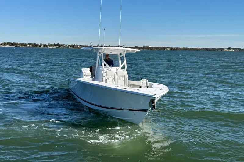 Slide: The Image of 2026 Jupiter 32 boat cruising on open water under clear blue sky. - 11