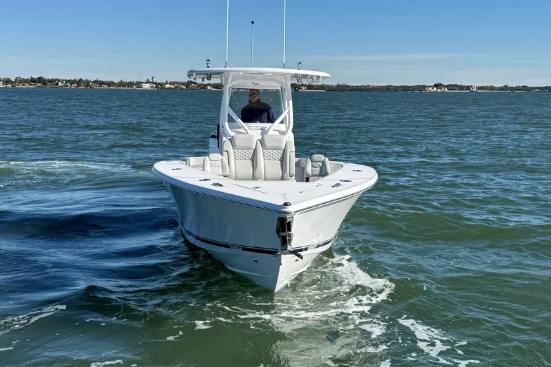 Slide: The Image of 2026 Jupiter 32 boat cruising on open water under clear blue sky. - 12