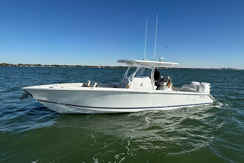 Slide: The Image of 2026 Jupiter 32 boat cruising on open water under clear blue sky. - 15
