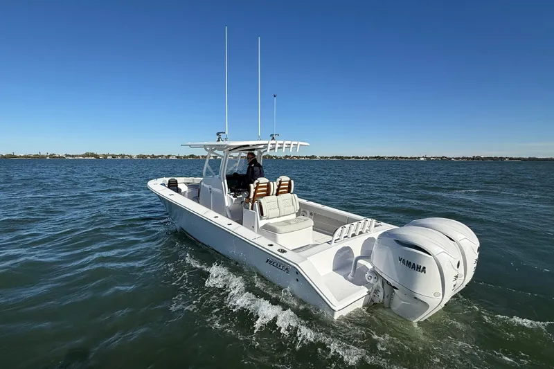 Slide: The Image of 2026 Jupiter 32 boat cruising on open water with Yamaha engines. - 16