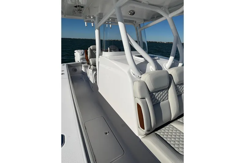 Slide: The Image of 2026 Jupiter 32 boat interior with modern seating and sleek design on open water. - 21
