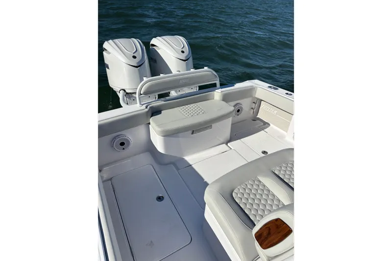Slide: The Image of 2026 Jupiter 32 boat interior with dual engines, featuring cushioned seating and sleek design. - 23