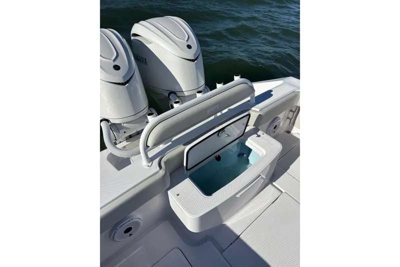 Slide: The Image of 2026 Jupiter 32 boat with open storage compartment and twin outboard engines. - 24