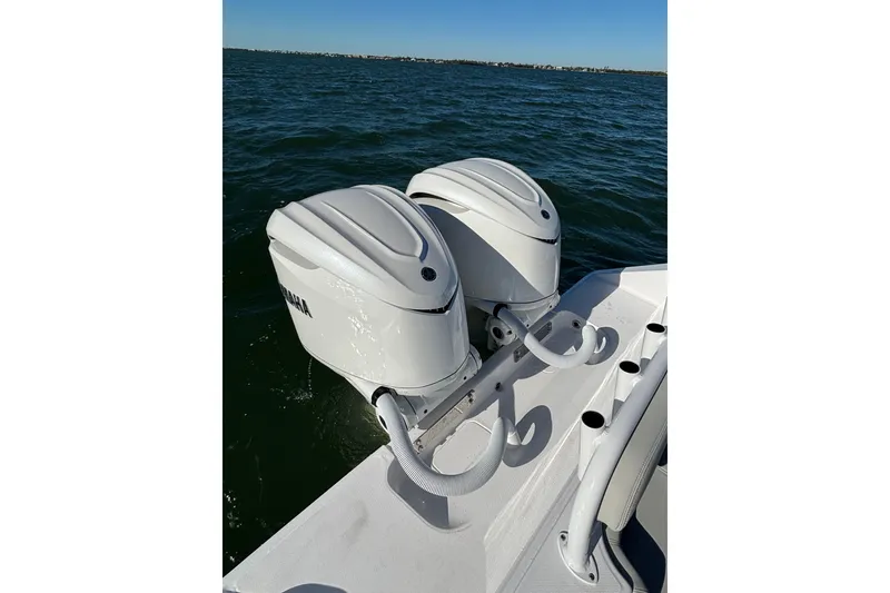 Slide: The Image of Twin Yamaha outboard motors on a 2026 Jupiter 32 boat, cruising on open water. - 31
