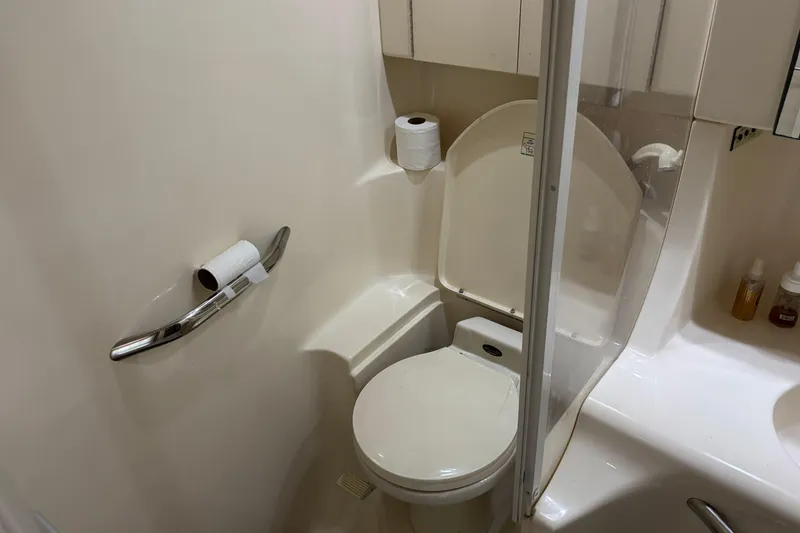 Slide: The Image of Bathroom interior of 1999 Sea Ray 380 Sundancer yacht, featuring toilet and shower. - 11